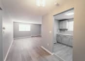 Thumbnail 14 of 24 - an empty living room and kitchen with wood floors and a window at BAY SHORE APARTMENTS, EAST HAVEN, CT, 06512