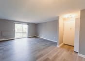 Thumbnail 9 of 24 - a living room and dining room of an empty house with wood flooring  at BAY SHORE APARTMENTS, EAST HAVEN, 06512