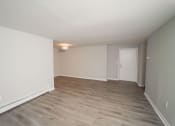 Thumbnail 1 of 19 - an empty living room with wood floors and white walls at Enclave West Hartford / Parc West, West Hartford, 06110