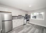 Thumbnail 12 of 39 - an empty kitchen with stainless steel appliances and white cabinets at Encore 99, East Haven, 06512