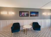 Thumbnail 3 of 27 - a living room with blue chairs and a white table at Five High, West Hartford