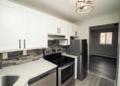 Thumbnail 5 of 27 - a kitchen with stainless steel appliances and white cabinets at Five High, West Hartford, 06119