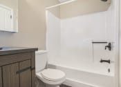 Thumbnail 13 of 24 - a bathroom with a toilet and a tub and a sink at Retro 511 Apartments, Connecticut