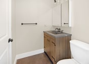 Thumbnail 7 of 24 - a bathroom with a toilet sink and a mirror at Retro 511 Apartments, West Haven