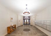 Thumbnail 2 of 24 - a long hallway with rows of lockers and a chandelier at Retro 511 Apartments, West Haven, CT 06516