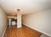 Thumbnail 17 of 24 - a renovated living room and kitchen with wood floors and white walls at Retro 511 Apartments, West Haven, 06516