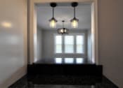 Thumbnail 54 of 55 - three lights hanging over a window in a room with a black counter at The Packard, West Hartford, 06119