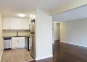 Thumbnail 30 of 55 - an empty kitchen with white cabinets and a stainless steel refrigerator at The Packard, West Hartford