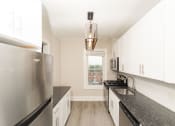 Thumbnail 23 of 55 - a kitchen with granite counter tops and stainless steel appliances at The Packard, West Hartford, Connecticut