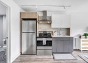 Thumbnail 20 of 41 - a small kitchen with stainless steel appliances and white cabinets at Up House, Farmington, 06032