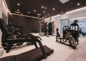 Thumbnail 32 of 41 - a gym with treadmills and other exercise equipment on a white floor at Up House, Farmington, Connecticut