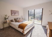 Thumbnail 8 of 41 - a bedroom with a bed and a sliding glass door at Up House, Farmington