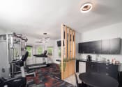 Thumbnail 17 of 33 - a home gym with a table and chairs and a work out area at Woodbury, Woodbury