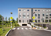 Thumbnail 20 of 23 - a building with a bridge and a road in front of it