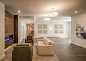 Thumbnail 1 of 23 - a long hallway with couches and chairs and a fireplace