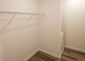Thumbnail 18 of 33 - Empty room with a white wall and a wooden floor.