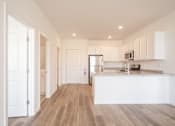 Thumbnail 10 of 23 - a kitchen with white cabinets and a white counter top
