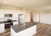 Thumbnail 8 of 23 - a kitchen with white cabinets and stainless steel appliances
