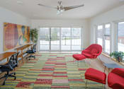Thumbnail 14 of 14 - A room with a red carpet and a ceiling fan.
