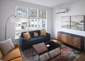 Thumbnail 15 of 32 - A living room with a blue couch and a wooden coffee table.