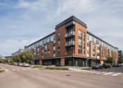 Thumbnail 27 of 41 - a large brick building on the corner of a street