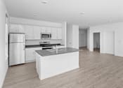 Thumbnail 16 of 30 - A modern kitchen with a refrigerator, microwave, oven, and sink.