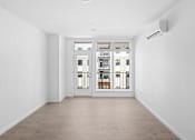 Thumbnail 26 of 30 - A white room with a sliding door and a window.