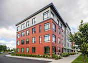 Thumbnail 38 of 42 - a view of the front of the building with a sidewalk in front of it and trees in