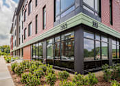 Thumbnail 36 of 42 - a building with large windows and a green and red facade