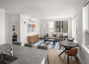 Thumbnail 15 of 30 - A modern kitchen with a dining table and chairs.