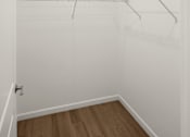 Thumbnail 24 of 30 - A white closet with a light on the ceiling.