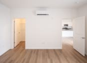 Thumbnail 19 of 41 - an empty living room with white walls and wood floors