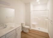 Thumbnail 22 of 41 - a bathroom with a toilet and a sink and a shower