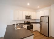 Thumbnail 23 of 41 - a kitchen with granite counter tops and stainless steel appliances