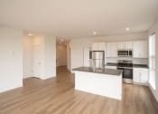 Thumbnail 18 of 41 - a kitchen with white cabinets and a large island in the middle
