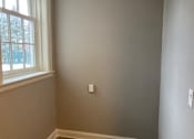 Thumbnail 14 of 24 - A room with a window and a light switch on the wall.