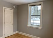 Thumbnail 10 of 24 - A room with a white door and a window.