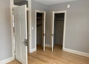 Thumbnail 24 of 24 - A room with a white door and two other doors with no windows.