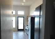 Thumbnail 15 of 18 - A room with a large window and a flat screen TV mounted on the wall.