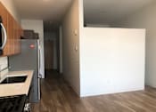 Thumbnail 18 of 18 - A kitchen with a refrigerator and a countertop.
