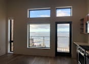 Thumbnail 14 of 18 - A kitchen with a view of the water.