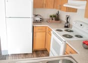 Thumbnail 15 of 15 - a kitchen with a stove and a refrigerator