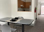 Thumbnail 10 of 15 - a kitchen and dining room with a table and chairs