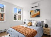 Thumbnail 6 of 30 - A bedroom with a large bed and a painting on the wall.