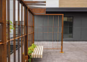 Thumbnail 30 of 33 - A wooden structure with glass panels is surrounded by a concrete floor.