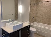 Thumbnail 17 of 17 - A bathroom with a sink, toilet, and bathtub.