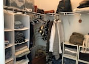 Thumbnail 12 of 17 - A white closet with clothes and bags.