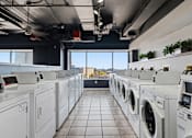 Thumbnail 74 of 151 - A row of washing machines in a laundromat.