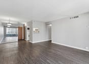 Thumbnail 91 of 151 - A room with wooden floors and white walls.