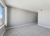 Thumbnail 127 of 151 - A room with grey carpet and white walls.